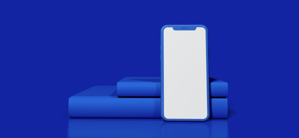 Phone being held up by two books of different lengths on blue background