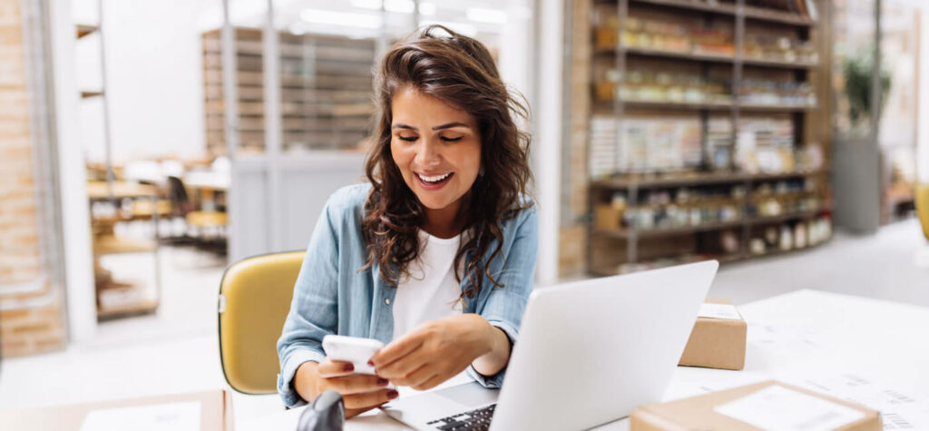 Person smiling on phone in office space