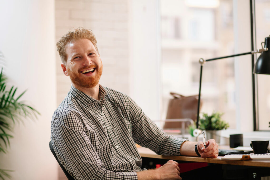 Person smiling at desk while working