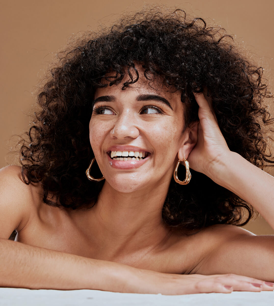 Women smiling, looking off camera.